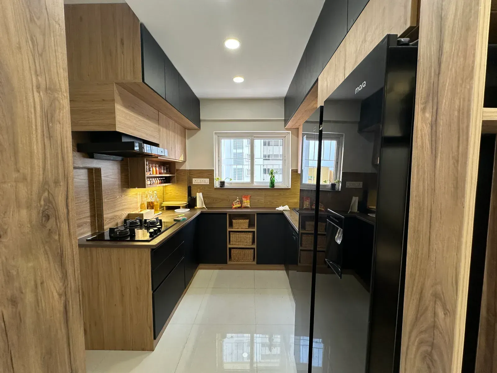 Black and oak modular kitchen with tall appliance unit — The Aakar